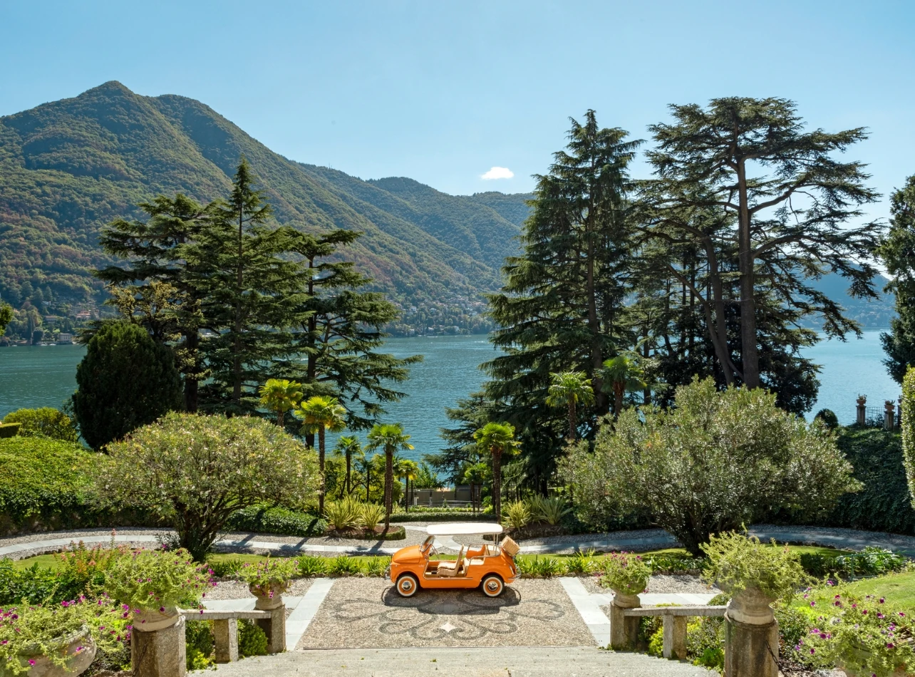 A colourful vintage Spiaggina car in the lakeside gardens at Passalacqua, Lake Como